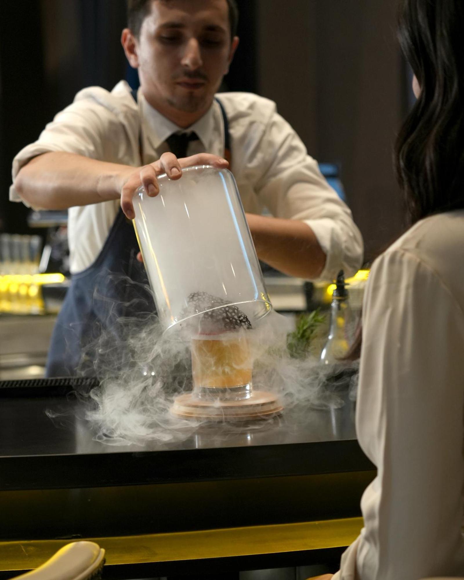 Fairmont Riyadh Exterior photo A bartender preparing a cocktail with liquid nitrogen